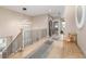Bright hallway featuring hardwood floors, stylish runners, modern lighting and neutral walls at 5420 Baseline Rd, Boulder, CO 80303