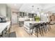 Kitchen island with bar stool seating and pendant lights hanging over a large quartz countertop at 5420 Baseline Rd, Boulder, CO 80303