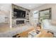 Inviting living room featuring a stacked stone fireplace and plenty of natural light at 5420 Baseline Rd, Boulder, CO 80303