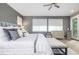 Spacious main bedroom featuring windows with blinds, a ceiling fan, and a decorative dresser at 5420 Baseline Rd, Boulder, CO 80303