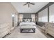 Stylish main bedroom featuring a ceiling fan, neutral walls, textured wallpaper, bench, and a sliding door at 5420 Baseline Rd, Boulder, CO 80303