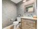 Chic powder room featuring a rustic vanity, and patterned wallpaper at 5420 Baseline Rd, Boulder, CO 80303