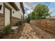 Side yard featuring a decorative rock bed, lush greenery, and privacy fencing at 5420 Baseline Rd, Boulder, CO 80303