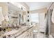 Double vanity bathroom with granite countertop and shower at 13795 W Center Dr, Lakewood, CO 80228