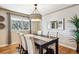 Elegant dining room featuring a large table and modern light fixture at 13795 W Center Dr, Lakewood, CO 80228