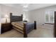 Well-lit bedroom features hardwood floors, a ceiling fan, a large bed, and bedside lamps at 23 Shetland Ct, Highlands Ranch, CO 80130
