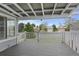 Covered porch area with white railing offering beautiful views of the surrounding neighborhood at 23 Shetland Ct, Highlands Ranch, CO 80130