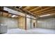 Unfinished basement featuring exposed ceiling and concrete walls, ready for customization and featuring a stairway at 930 Button Rock Dr # 29, Longmont, CO 80504