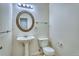Clean bathroom featuring a pedestal sink, decorative mirror, and tiled floor at 930 Button Rock Dr # 29, Longmont, CO 80504