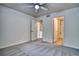 Bright bedroom features neutral walls, carpet, a ceiling fan, and ensuite bath at 930 Button Rock Dr # 29, Longmont, CO 80504