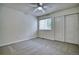 Cozy bedroom with a ceiling fan, large window, and a closet space at 930 Button Rock Dr # 29, Longmont, CO 80504