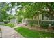 Well-maintained townhome with a sidewalk and lush greenery at 930 Button Rock Dr # 29, Longmont, CO 80504