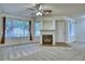 Bright living room with a fireplace and neutral carpet at 930 Button Rock Dr # 29, Longmont, CO 80504