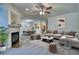 Bright open-concept living room features a fireplace and flows into the dining area and kitchen at 930 Button Rock Dr # 29, Longmont, CO 80504