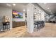 Basement bar area with pendant lights, a popcorn machine, and a TV at 19495 W 94Th Ave, Arvada, CO 80007