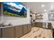 Basement kitchen features stainless steel appliances, wood-look floors, and ample storage at 19495 W 94Th Ave, Arvada, CO 80007
