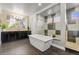 Stylish bathroom featuring a freestanding tub, a tiled shower, and modern fixtures at 19495 W 94Th Ave, Arvada, CO 80007