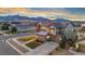 Beautiful two-story home featuring stone accents, a well-manicured lawn, and mountain views in the background at 19495 W 94Th Ave, Arvada, CO 80007