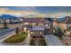 Beautiful two-story home featuring stone accents, a well-manicured lawn, and mountain views in the background at 19495 W 94Th Ave, Arvada, CO 80007