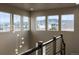 Bright foyer with modern lighting fixture, showcasing views of the neighborhood and mountains at 19495 W 94Th Ave, Arvada, CO 80007