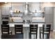Stylish kitchen with a large island, pendant lighting, stainless appliances and open shelving at 19495 W 94Th Ave, Arvada, CO 80007