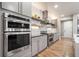 Modern kitchen features stainless steel appliances, gray cabinets and hardwood flooring at 19495 W 94Th Ave, Arvada, CO 80007
