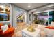 Open-concept living room with hardwood floors, modern decor, and seamless access to the backyard at 19495 W 94Th Ave, Arvada, CO 80007