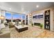 Inviting living room with a fireplace, built-in shelving, and large windows with neighborhood views at 19495 W 94Th Ave, Arvada, CO 80007