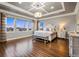 Spacious main bedroom with tray ceiling, hardwood floors, and large windows, providing ample natural light at 19495 W 94Th Ave, Arvada, CO 80007