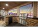 Outdoor kitchen featuring stone accents, built-in grill, mini refrigerator and neighborhood view at 19495 W 94Th Ave, Arvada, CO 80007
