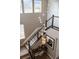 Modern staircase with decorative lighting fixtures, black metal railings and wall art at 19495 W 94Th Ave, Arvada, CO 80007