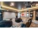 State-of-the-art media room featuring a large screen, comfortable seating, and professional sound system for immersive entertainment at 19495 W 94Th Ave, Arvada, CO 80007