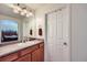 Bright bathroom with a double sink vanity and view into bedroom at 3805 Windriver Trl, Castle Rock, CO 80109