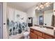 Clean bathroom with wood vanity, shower/tub, and updated fixtures at 3805 Windriver Trl, Castle Rock, CO 80109