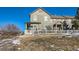 Two-story home with a snowy yard and a white picket fence at 3805 Windriver Trl, Castle Rock, CO 80109