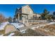 Two-story home with white picket fence, snowy yard, and sidewalk at 3805 Windriver Trl, Castle Rock, CO 80109