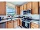 Modern kitchen with stainless steel appliances and light wood cabinets at 3805 Windriver Trl, Castle Rock, CO 80109