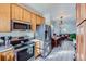 Open concept kitchen with stainless steel appliances and view into living room at 3805 Windriver Trl, Castle Rock, CO 80109