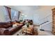 Living room with leather sofas, coffee table, and view of staircase at 3805 Windriver Trl, Castle Rock, CO 80109