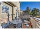 Small patio with table and chairs and some snow on the ground at 3805 Windriver Trl, Castle Rock, CO 80109