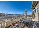 Patio with table, chairs, and umbrella; views of the neighborhood at 3805 Windriver Trl, Castle Rock, CO 80109