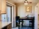 Cozy dining area with black table, blue chairs and sliding glass doors leading to the patio at 1614 Secrest St, Golden, CO 80401
