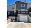 Charming multi-level home featuring a one-car garage, a balcony, and a well-maintained front yard with stairs to the entry at 1614 Secrest St, Golden, CO 80401