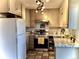 Charming kitchen with stainless steel appliances, granite countertops and tiled floor at 1614 Secrest St, Golden, CO 80401