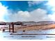 Scenic winter landscape with snow-covered fields and rolling hills under a cloudy blue sky at 1614 Secrest St, Golden, CO 80401