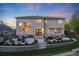 Expansive backyard with a patio, fire pit, built-in grill, and lush greenery at 5364 Dunraven Cir, Golden, CO 80403
