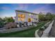 Beautiful backyard featuring a patio area, fire pit, and well-manicured lawn at 5364 Dunraven Cir, Golden, CO 80403