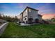 Lush backyard with a patio area, outdoor seating, and beautiful landscaping at 5364 Dunraven Cir, Golden, CO 80403