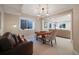 Comfortable finished basement with a seating area, wooden table, and a view of the window well at 5364 Dunraven Cir, Golden, CO 80403