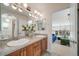 Dual sink bathroom vanity with tile countertop, framed mirrors, updated fixtures, and great lighting at 5364 Dunraven Cir, Golden, CO 80403